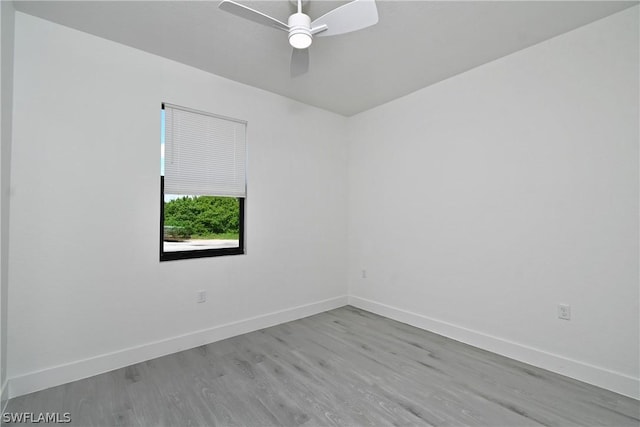 empty room with ceiling fan and light hardwood / wood-style floors