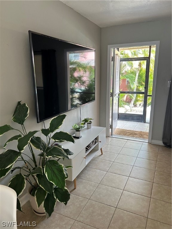 doorway to outside with light tile floors