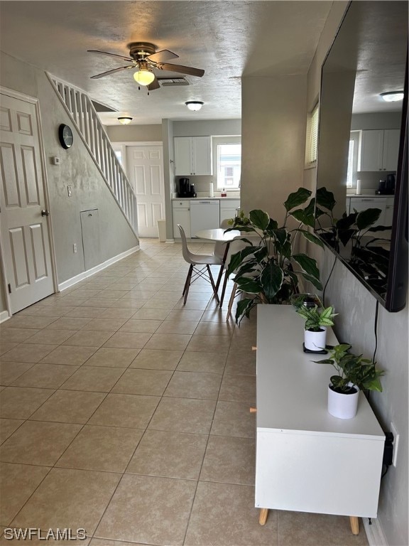 dining space featuring light tile floors and ceiling fan