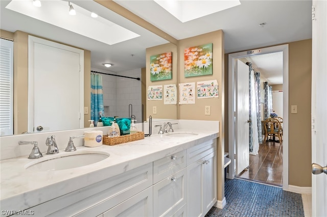 bathroom featuring a skylight, double sink vanity, tile flooring, and shower / bath combo