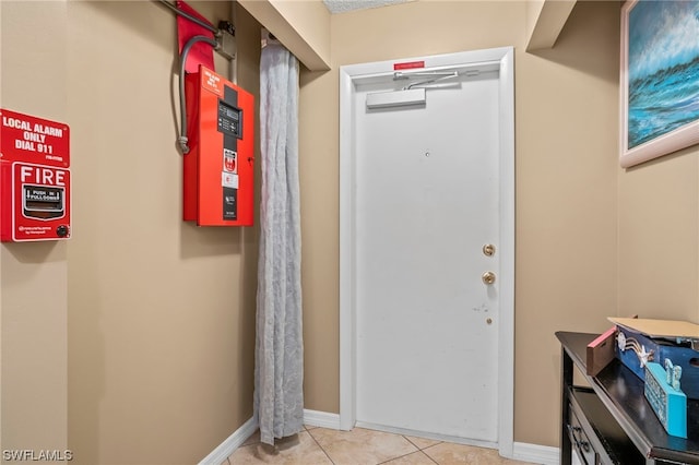 doorway to outside with light tile flooring