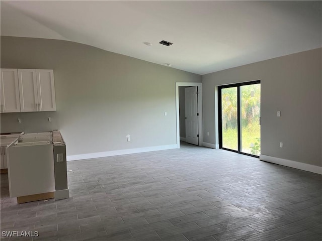 unfurnished living room with light wood-type flooring and vaulted ceiling