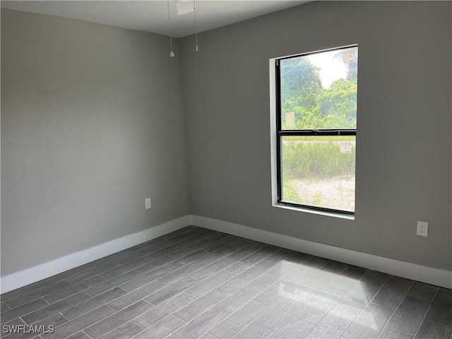 empty room with light wood-type flooring and a wealth of natural light