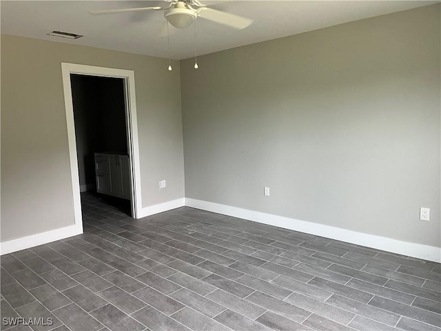 unfurnished room with dark hardwood / wood-style floors and ceiling fan