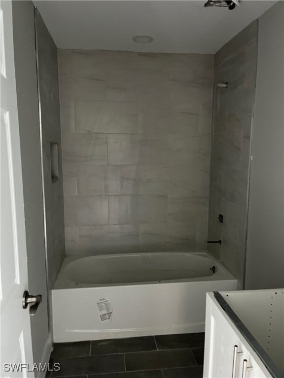 bathroom featuring tile patterned floors and tiled shower / bath