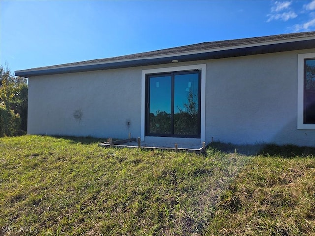 view of property exterior with a yard