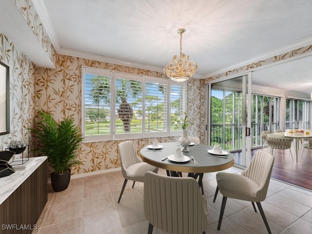 tiled dining area featuring a chandelier and ornamental molding