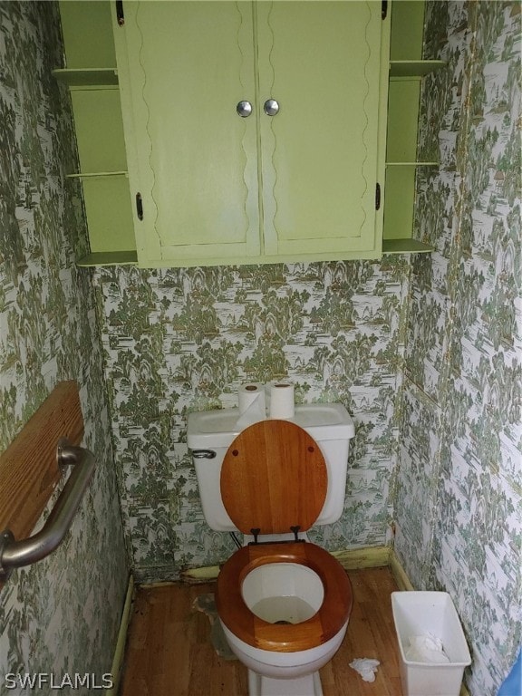 bathroom featuring toilet and wood-type flooring