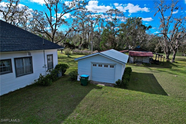 view of yard featuring an outbuilding and a garage