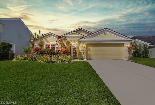 view of front of property featuring a lawn and a garage