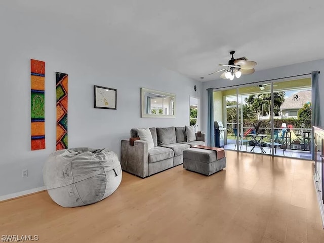 living room with light hardwood / wood-style flooring and ceiling fan