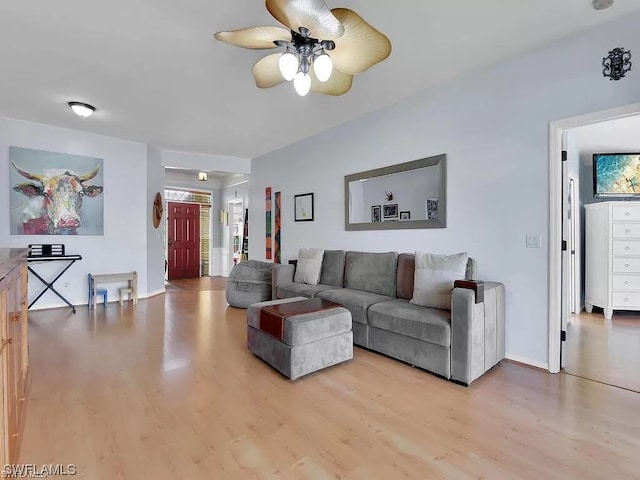 living room featuring ceiling fan and light hardwood / wood-style flooring