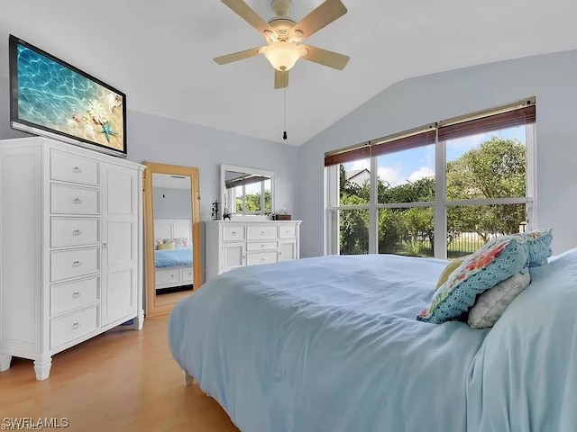 bedroom featuring light hardwood / wood-style floors, ceiling fan, and vaulted ceiling