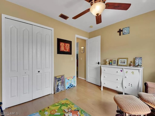 recreation room featuring light hardwood / wood-style floors and ceiling fan