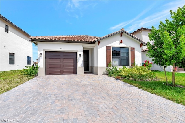 mediterranean / spanish-style house featuring a front lawn and a garage