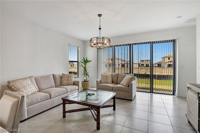 living room with light tile flooring and a notable chandelier