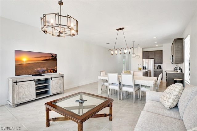 living room featuring light tile flooring and a notable chandelier