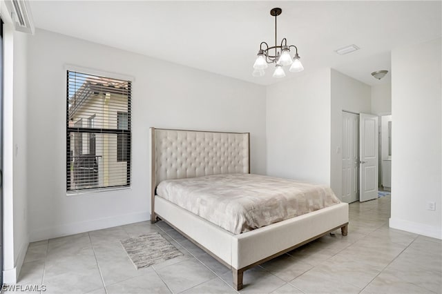 bedroom with light tile flooring and an inviting chandelier