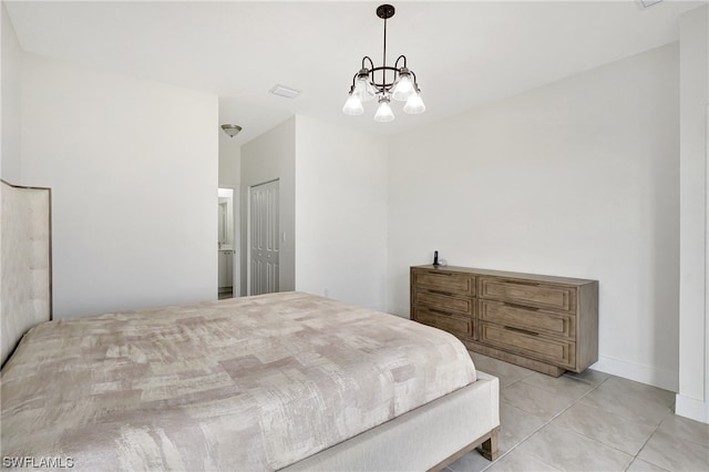 bedroom with a closet, light tile flooring, and a notable chandelier