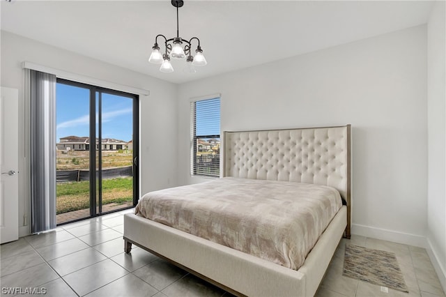 tiled bedroom featuring access to exterior, multiple windows, and a chandelier