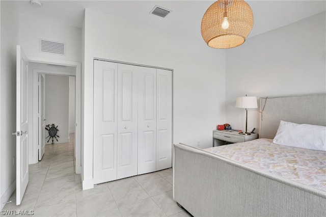 bedroom featuring a closet and light tile floors