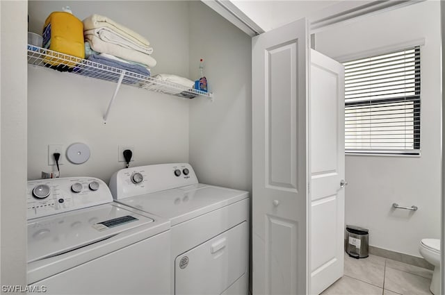 washroom featuring hookup for an electric dryer, independent washer and dryer, and light tile floors