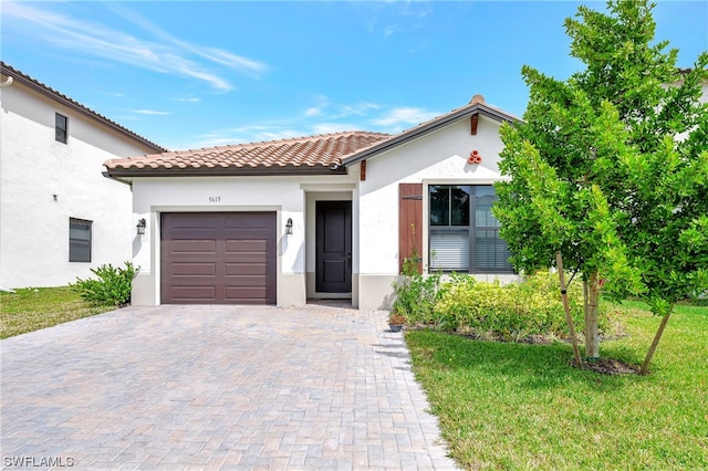 mediterranean / spanish-style home featuring a front yard and a garage