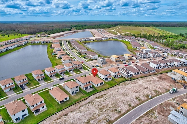 birds eye view of property with a water view