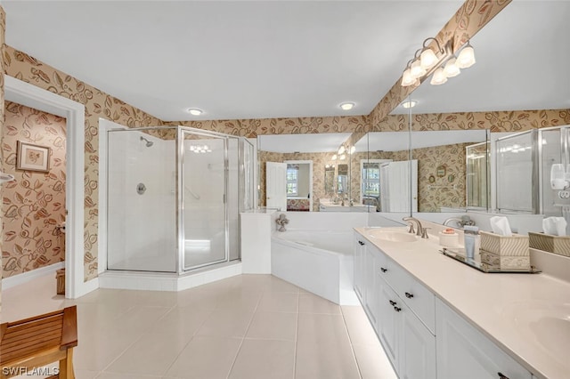 bathroom featuring tile floors, large vanity, dual sinks, and separate shower and tub