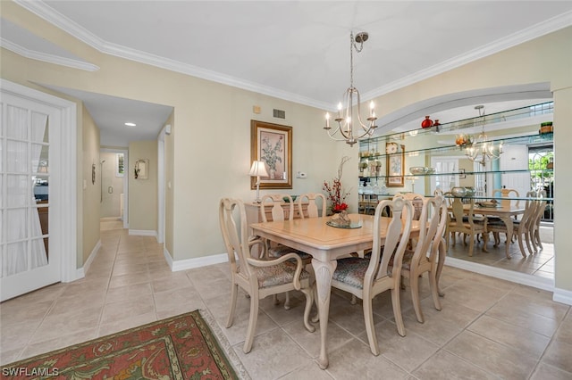 dining area with an inviting chandelier, crown molding, and light tile flooring