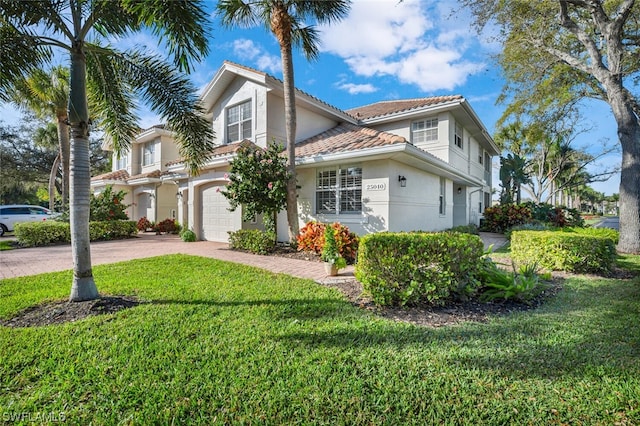 view of front of property with a front lawn and a garage