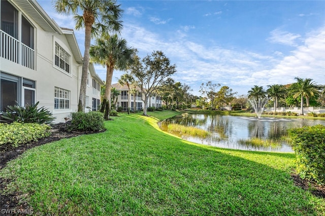 view of home's community featuring a yard and a water view