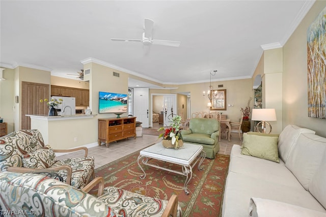 tiled living room featuring ornamental molding and ceiling fan with notable chandelier