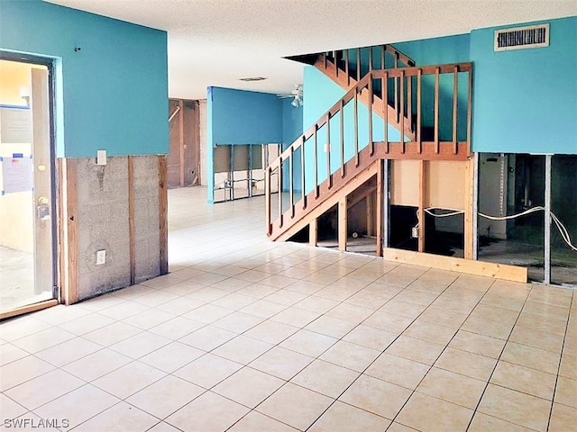 interior space featuring ceiling fan and light tile floors