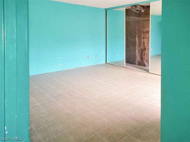 spare room with tile flooring