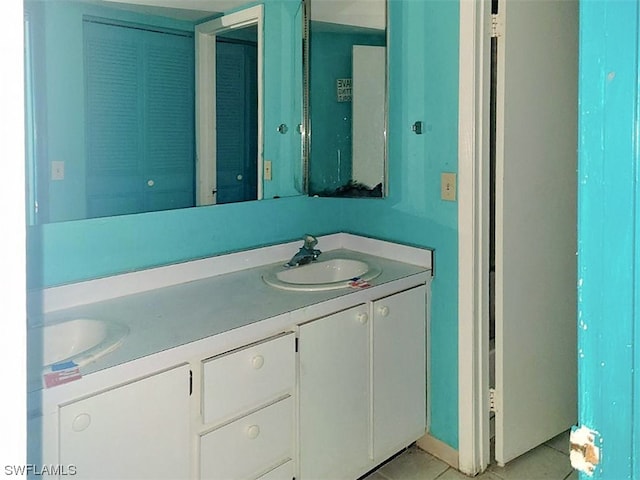 bathroom with tile floors, double sink, and large vanity