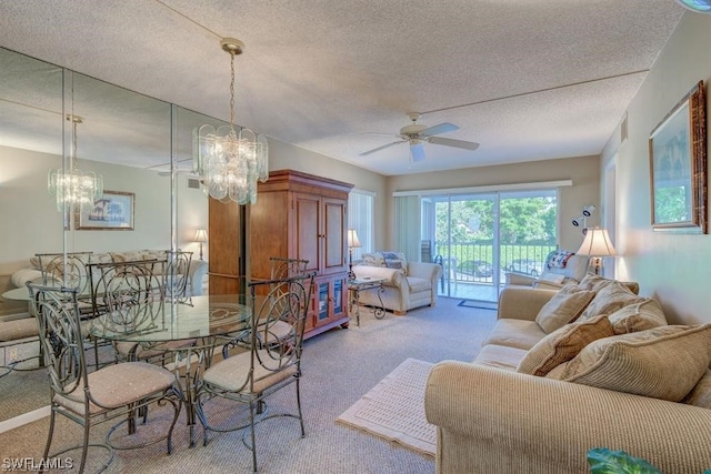 carpeted living room featuring a textured ceiling and ceiling fan with notable chandelier