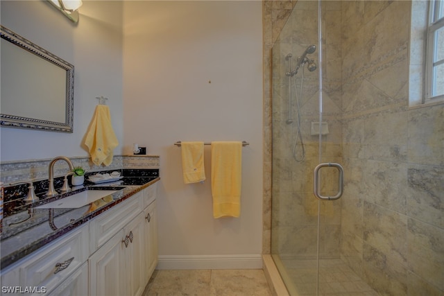 bathroom with a shower with door, tile floors, and vanity with extensive cabinet space