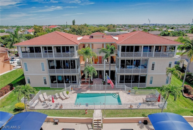 view of pool featuring a lawn and a patio area