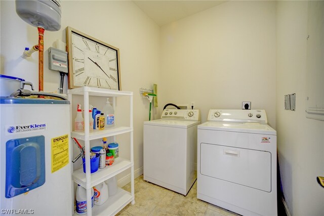 laundry area with washing machine and clothes dryer, electric dryer hookup, electric water heater, and light tile floors