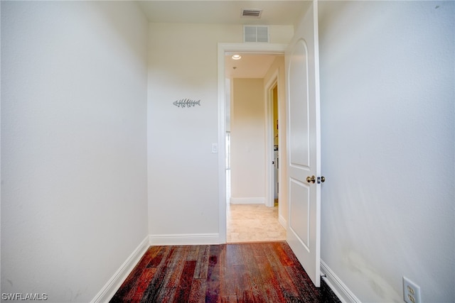 corridor with light hardwood / wood-style floors