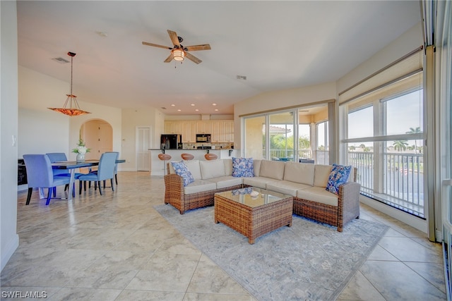 tiled living room featuring plenty of natural light and ceiling fan