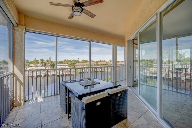 sunroom / solarium featuring plenty of natural light and ceiling fan