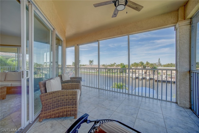 sunroom / solarium featuring ceiling fan and a wealth of natural light