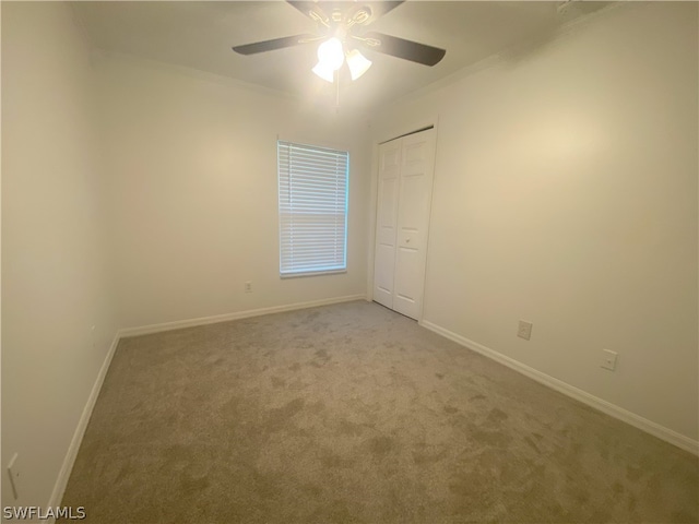 empty room with light carpet and ceiling fan