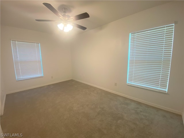 empty room featuring carpet flooring and ceiling fan