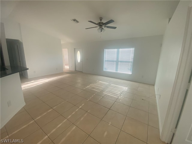 unfurnished room with ceiling fan and light tile flooring