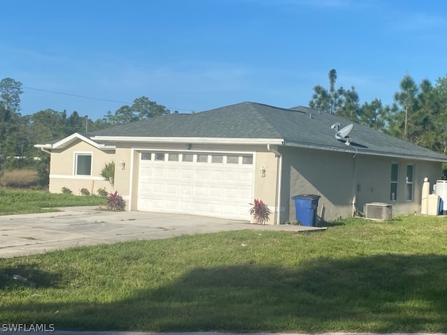 view of front of house featuring central AC unit, a front yard, and a garage