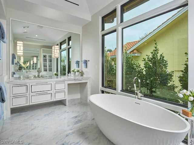 bathroom with vanity and a bathtub