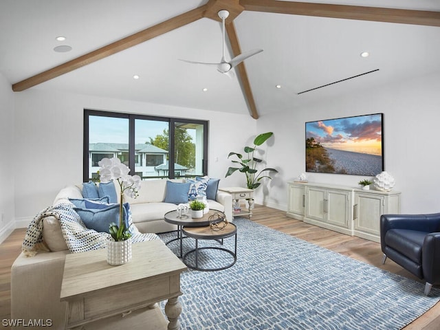 living room featuring lofted ceiling with beams, ceiling fan, and light wood-type flooring